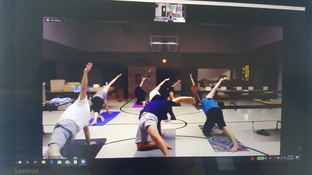 The Original Virtual Yoga Community Group in Rosholt SD. A school gym in Rosholt SD. full of yoga students who are practicing virtual yoga with Vallarta Breeze Yoga in Puerto Vallarta