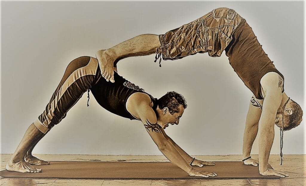 Jai and Manuel Jai and Victor Manuel in a couples Down Dog Pose