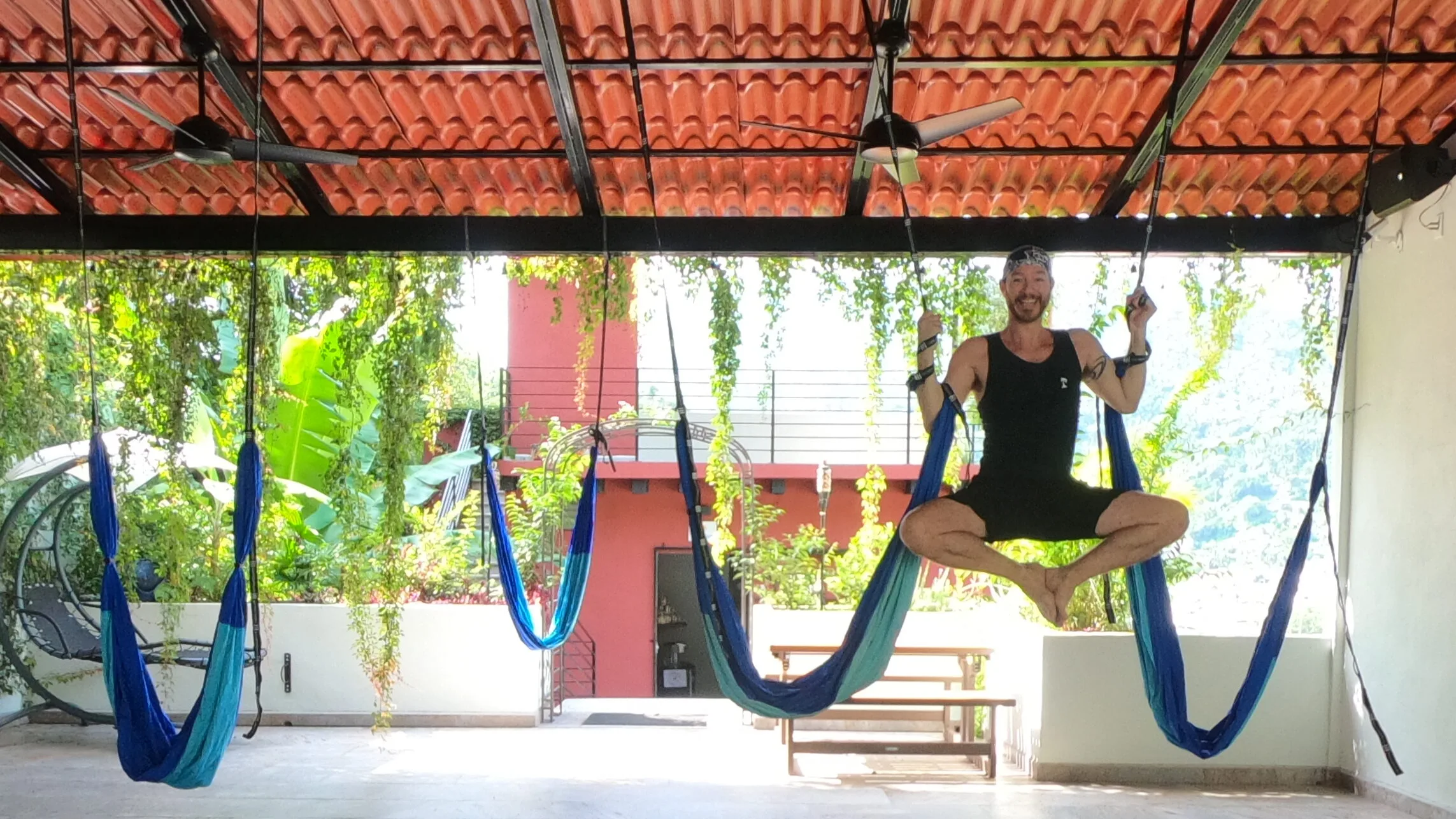 Aerial Yoga at the Vallarta Breeze Yoga Puerto Vallarta Yoga Studio aerial yoga student Hanging between two aerial yoga hammocks