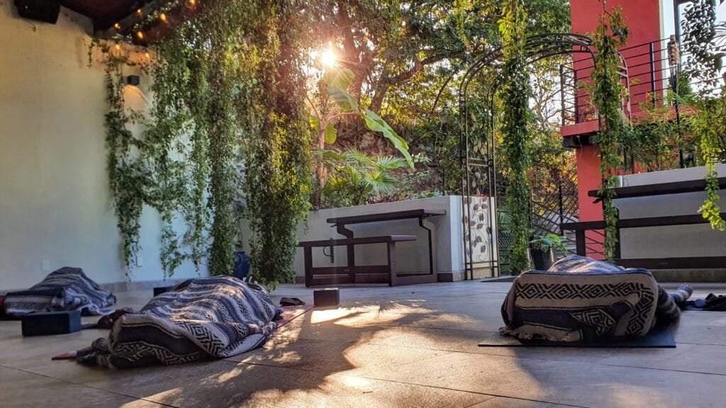 Sweet Savasana Yoga Students taking savasana as the sun rises behind them in the Vallarta Breeze Yoga Puerto Vallarta Yoga Studio
