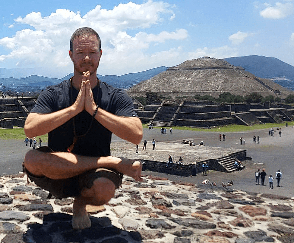 Toe Stand Padangustasana Yoga Teacher/Trainer Jai Salsbery E-RYT500, CPT, performing Toe Stand, Padangustasana, on top of a Pyramid at the Pyramids of Teotihuacan